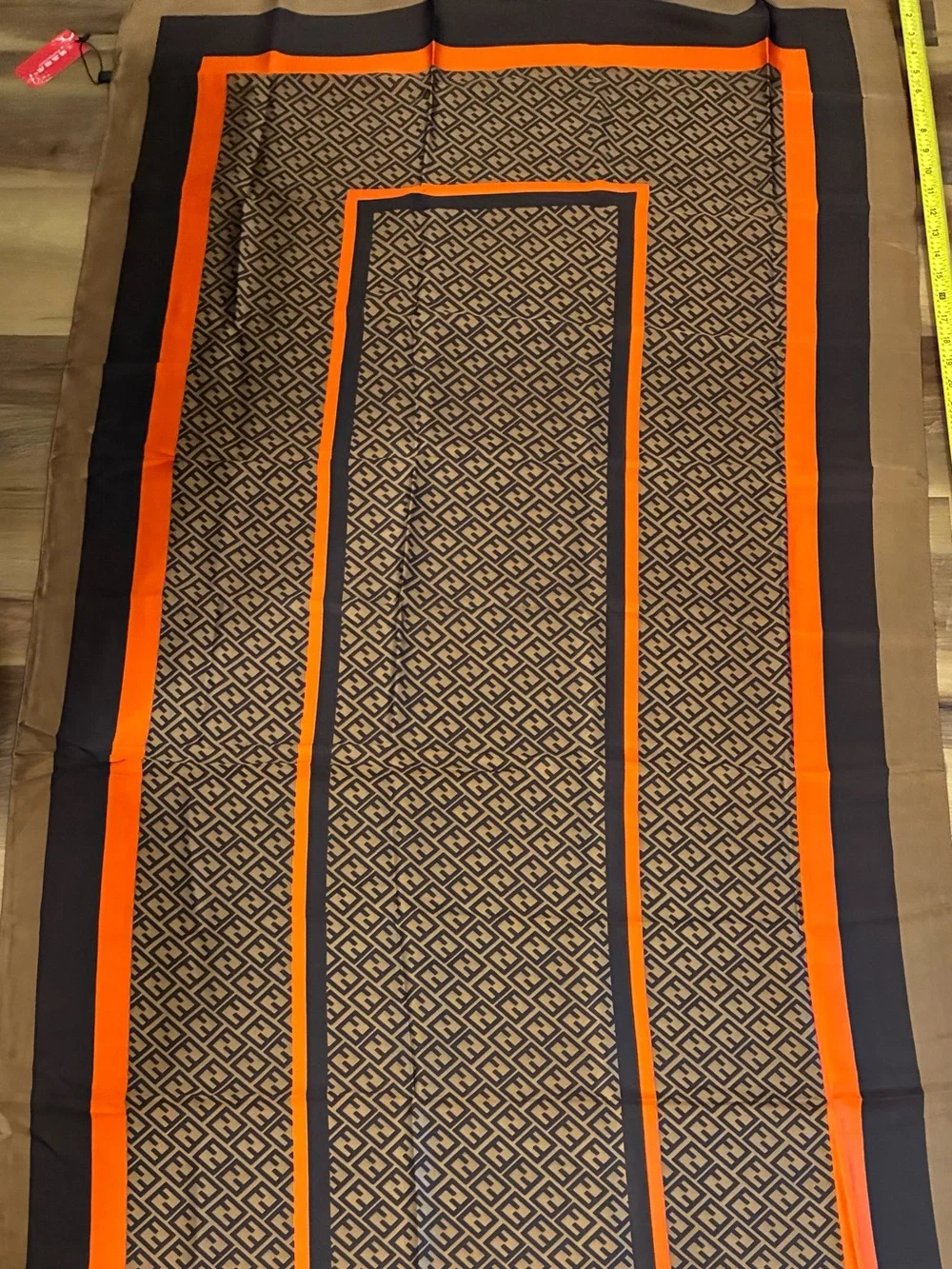 NWT brown and orange & tan geometric scarf. Polyester w/Silk feel. Approx 70 in